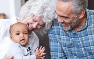 Do Grandparents Have Visitation Rights Maine portrayed by a grandmother, grandfather, and grand child all smiling.